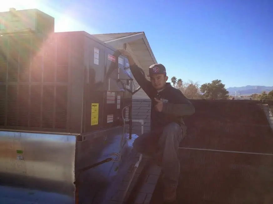 HVAC technician performing HVAC Inspection on a rooftop unit in Riverton